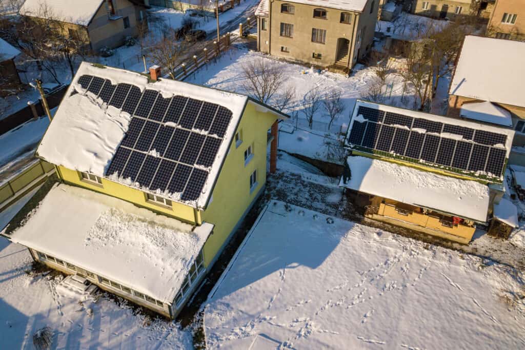 Snow melting off of solar panels on a roof.