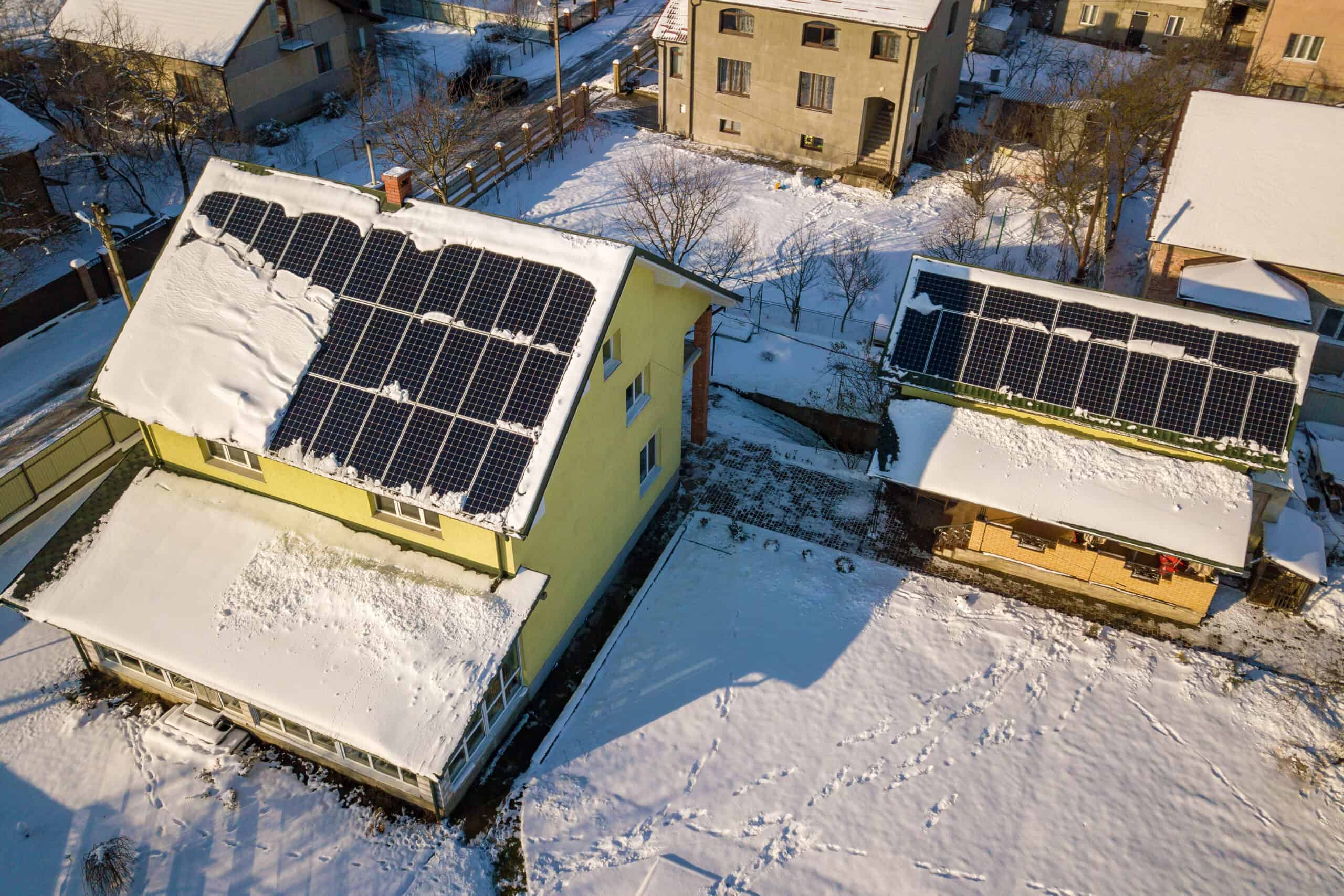 Snow melting off of solar panels on a roof.